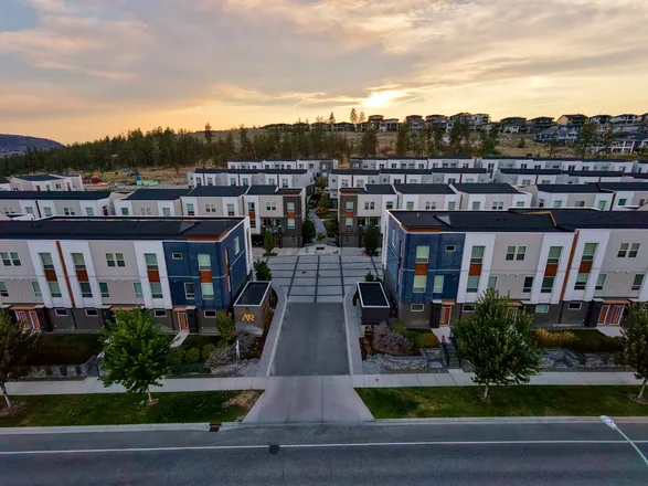 Aerial view of the Academy Ridge entrance signage and central plaza at dusk